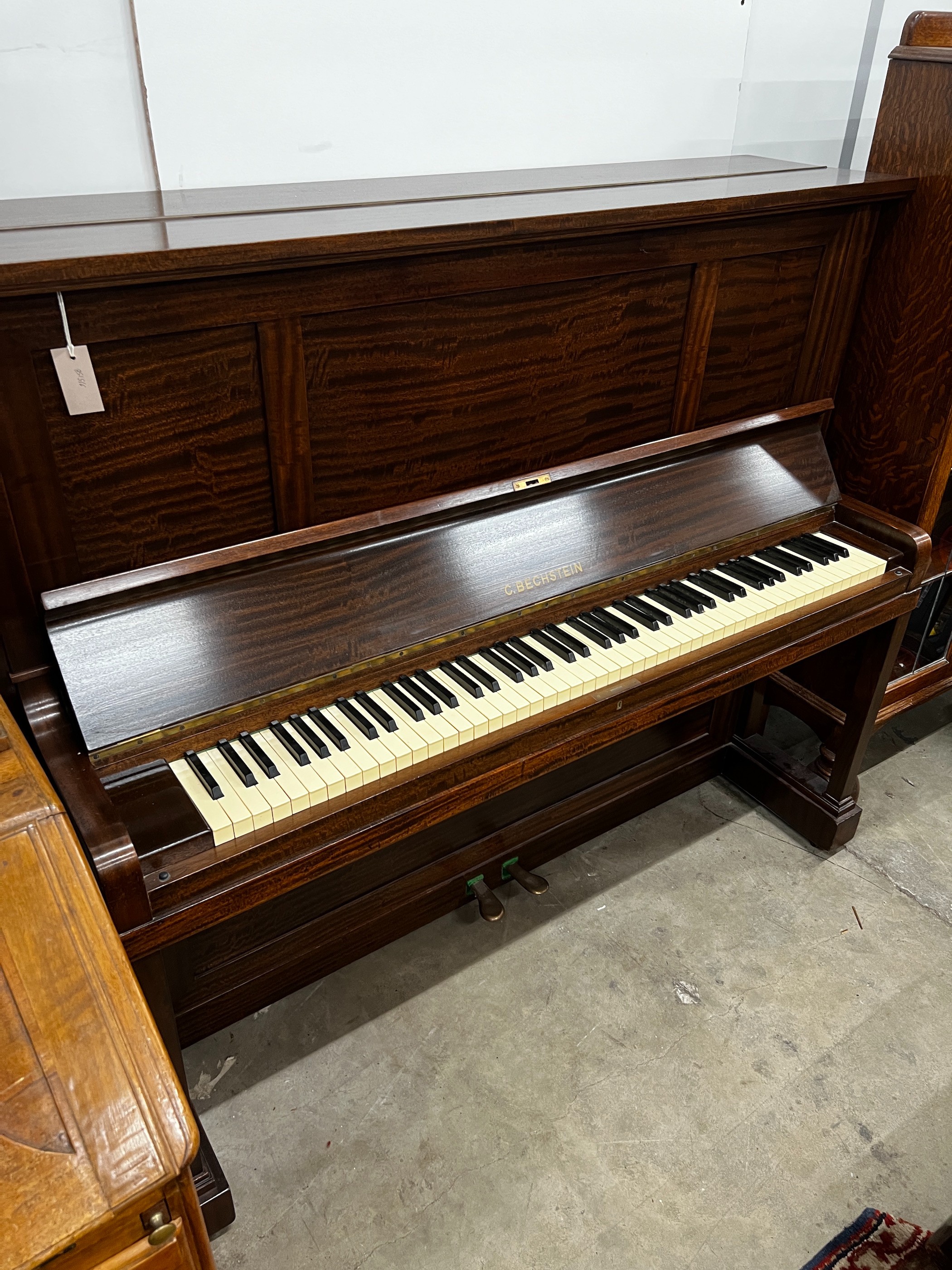 An early 20th century Bechstein mahogany cased upright piano, number 137164 (1929-30), width 156cm, height 129cm